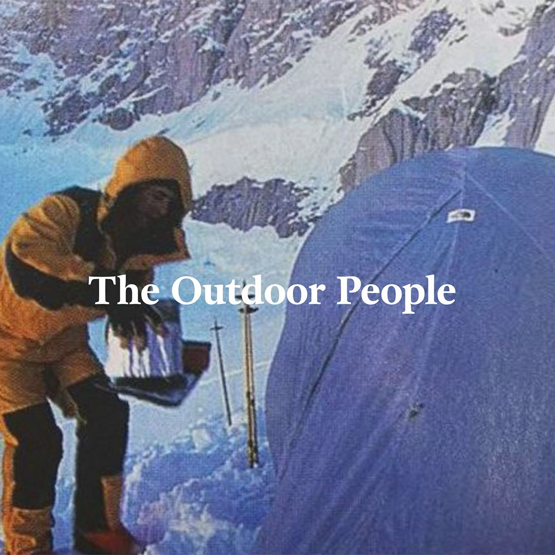 Person camping in the snow with branding saying The Outdoor People