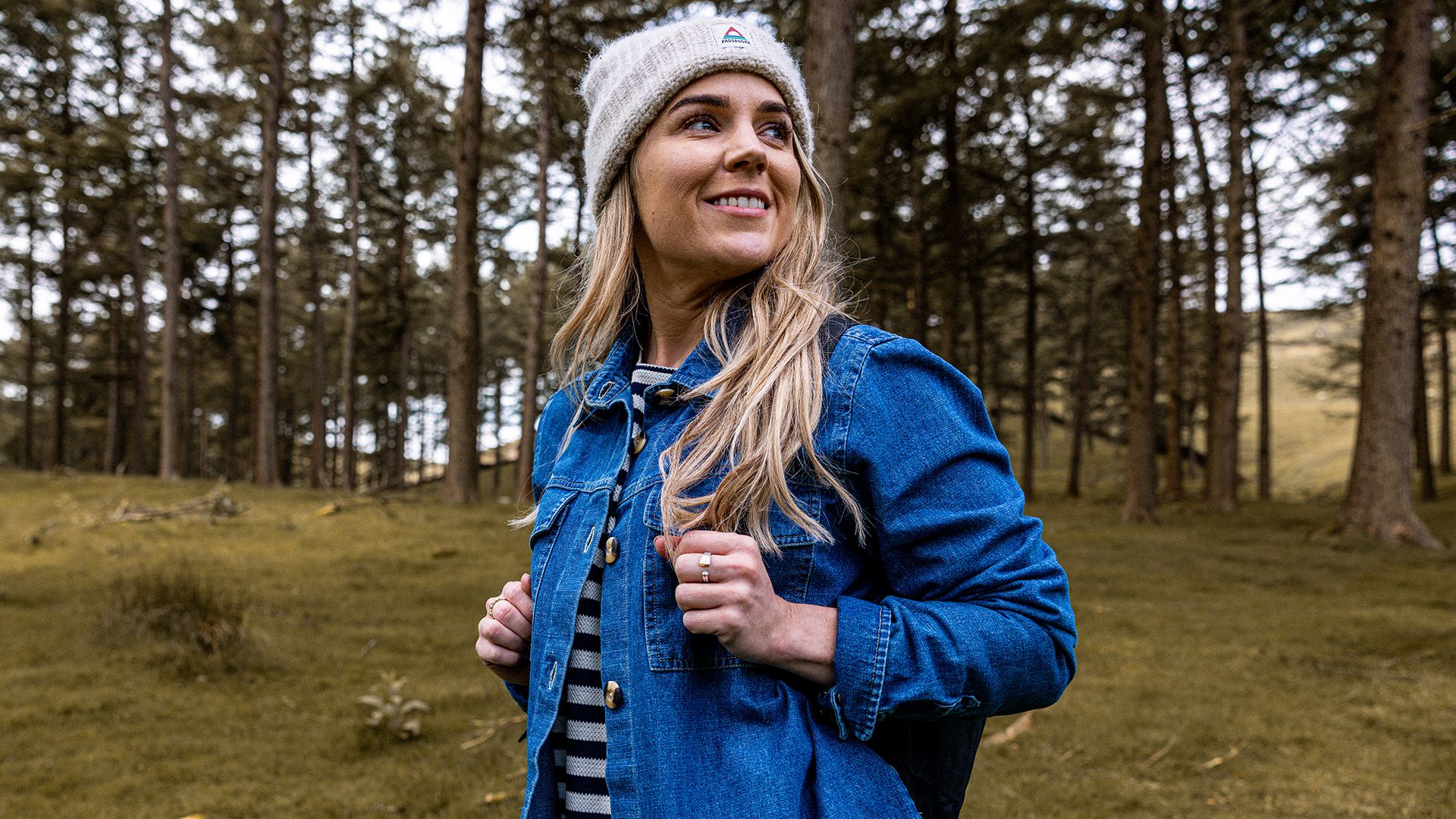 Woman with rucksack smiling and outdoors