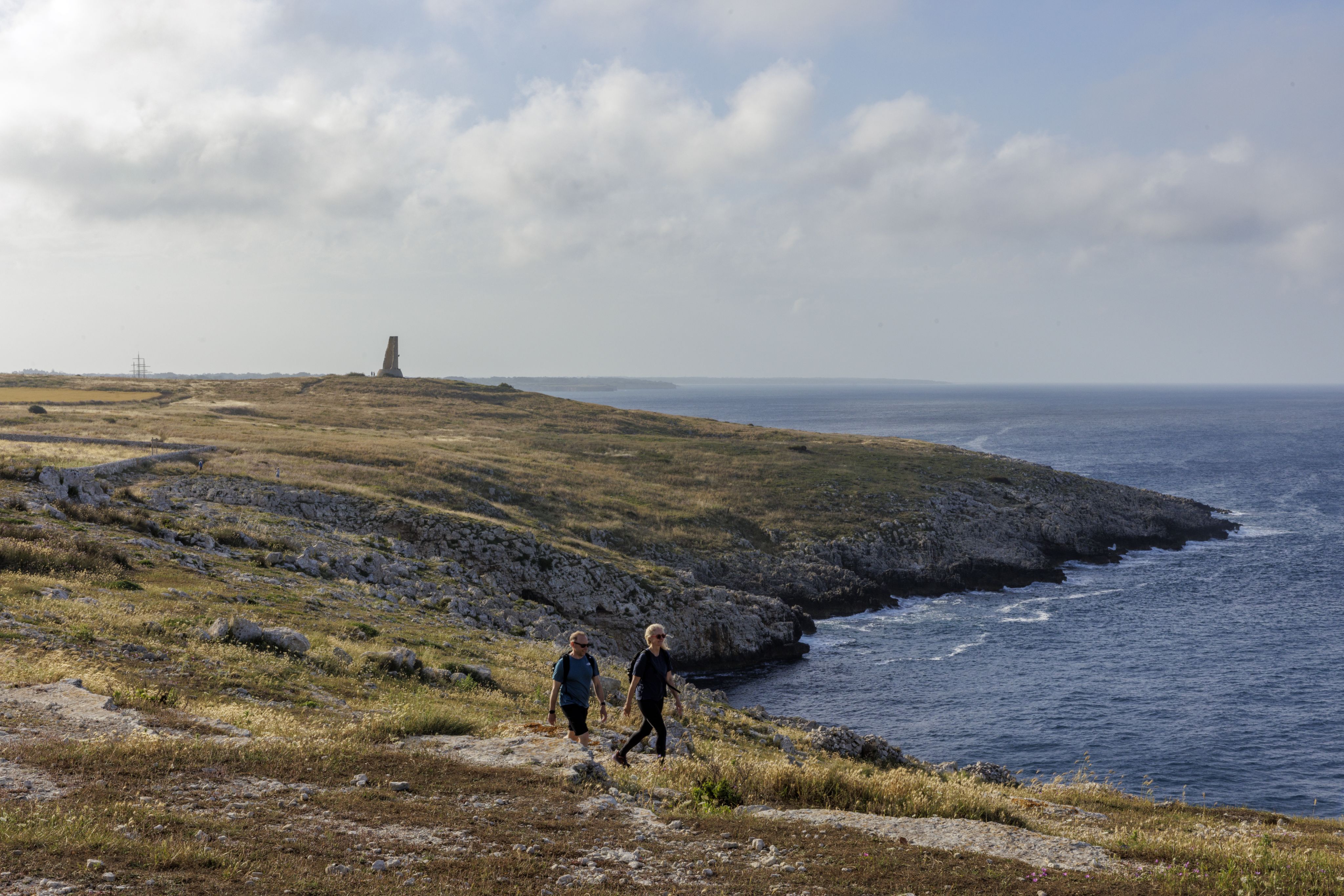 Woman standing in a cave by Malta coast